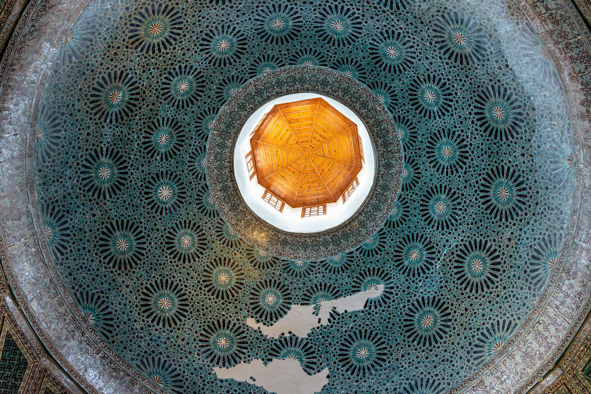 A beautifully designed dome ceiling featuring intricate geometric patterns and a central light source.