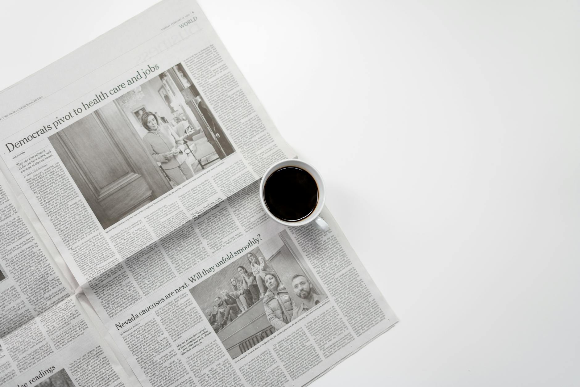 A fresh cup of coffee resting on a newspaper, perfect morning routine setup.