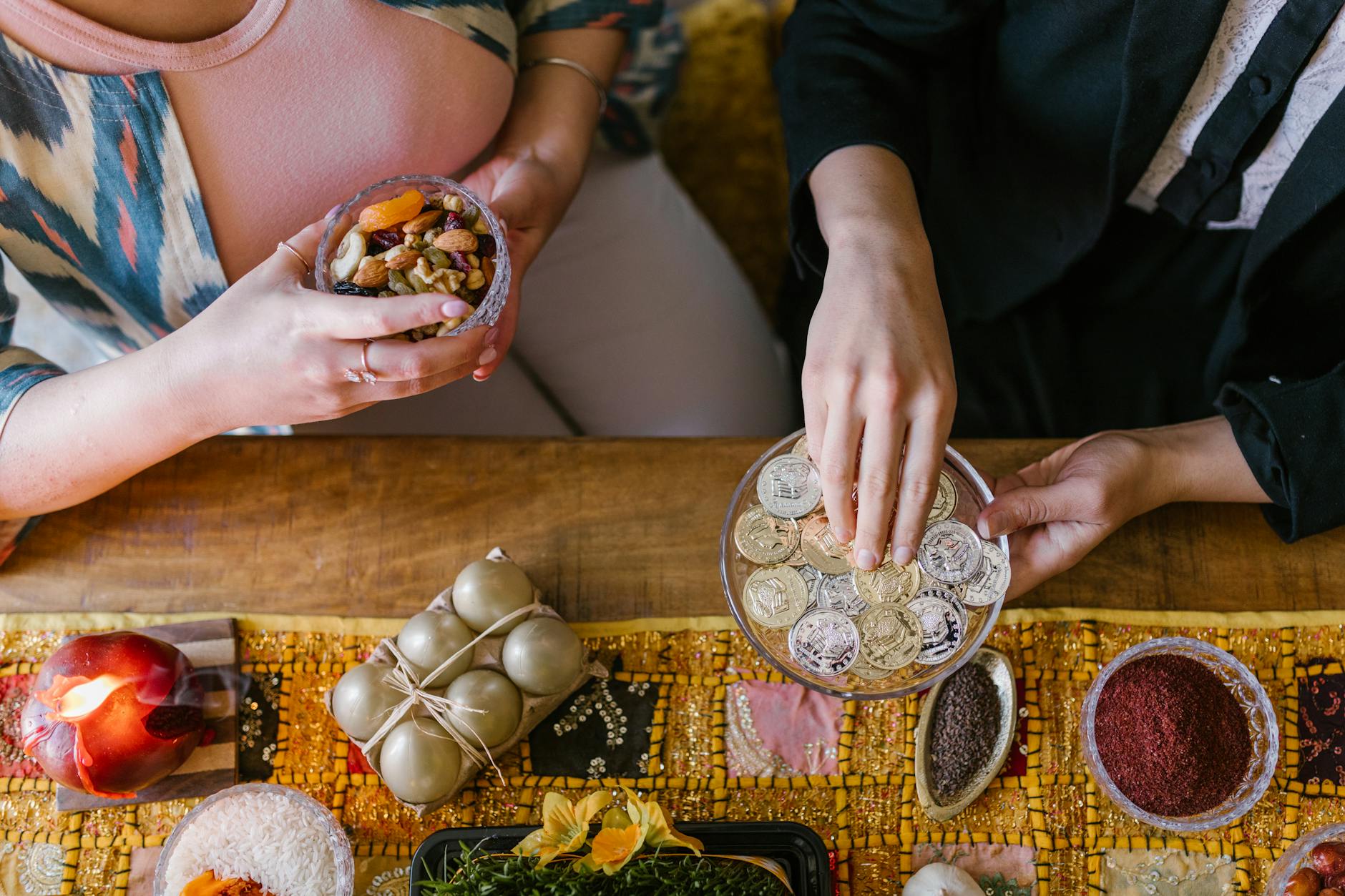 Top view of a decorated Haft-Sin table during Nowruz celebration with nuts and coins.